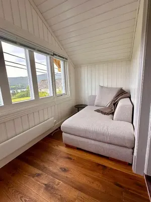 a small bedroom with a bed and two windows at Winter paradise Norefjell in Surteberg