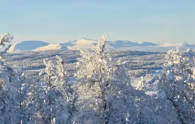 a snowy mountain with snow covered trees and mountains at Gorgeous Home In Gålå With House A Mountain View in Gålå