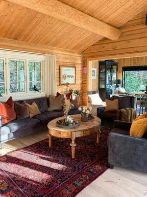 a living room with a couch and a coffee table at Timber Cabin With Hot Tub In Gjevilvassdalen in Oppdal