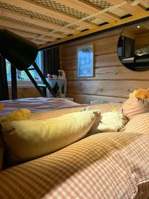 a room with two beds in a cabin at Timber Cabin With Hot Tub In Gjevilvassdalen in Oppdal