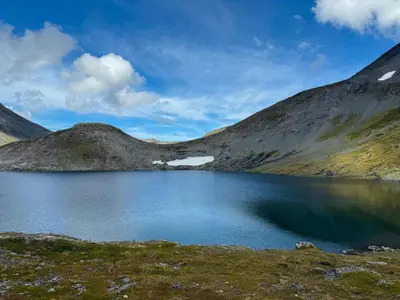 a lake in the middle of a mountain at Timber Cabin With Hot Tub In Gjevilvassdalen in Oppdal