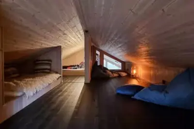 a bedroom with two beds and a window on the floor at Cabin At The Gateway To Jotunheimen in Tessand