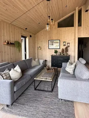 a living room with a couch and a table at Cabin At The Gateway To Jotunheimen in Tessand
