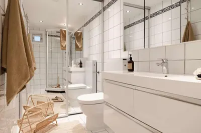 a white bathroom with a toilet and a sink at City apartment with balcony and 3 bedrooms! in Bergen