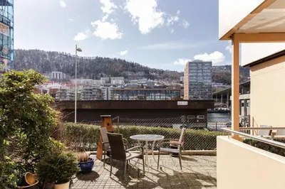 a patio with a table and chairs on a balcony at City apartment with balcony and 3 bedrooms! in Bergen