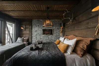 a bedroom with a bed with a cat laying on it at Fjellhytte Med Panorama På Toppen Av Norefjell in Noresund