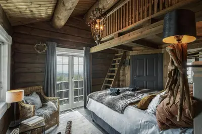 a bedroom with a bed in a room with wooden walls at Fjellhytte Med Panorama På Toppen Av Norefjell in Noresund