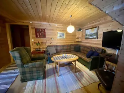 a living room with a couch and a table at Leilighet på fjellet nær Geilo in Hol