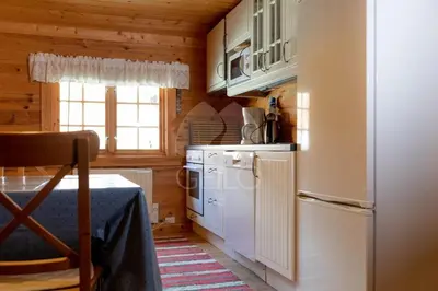 a kitchen with a white refrigerator and a stove at Leilighet på fjellet nær Geilo in Hol