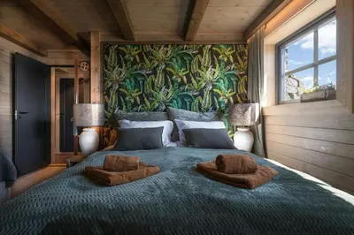 a bedroom with a large bed with two pillows on it at Designer Cabin For 16 With Spa In Turufjell in Flå