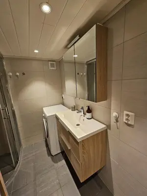 a bathroom with a sink and a mirror at Mausund- Øyperla i havet! Egen båtplass ved hytta! in Frøya