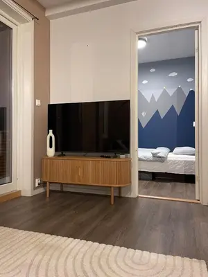 a living room with a large flat screen tv at Modern apartment - Balcony, Parking, BBQ in Vossevangen
