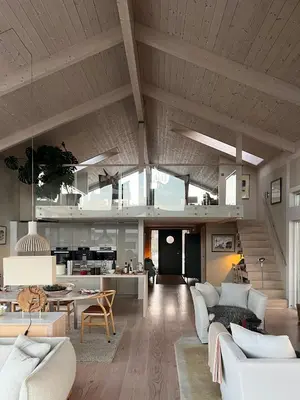 a living room with white furniture and a kitchen at Cottage With Sunny Terraces And Sea Views in Lysøysund