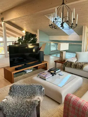 a living room with a large flat screen tv at Cottage With Sunny Terraces And Sea Views in Lysøysund