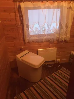 a bathroom with a toilet and a window at Live in the realm of the musk oxen on Dovrefjell in Hjerkinn
