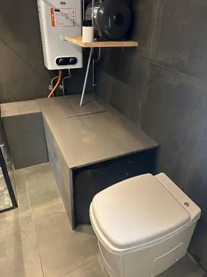 a bathroom with a white toilet and a counter at Sits in the middle of Reinheimen and Dovrefjell Rondane in Dombås