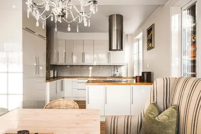 a kitchen with white cabinets and a chandelier at A Dream Home with Spectacular Views - NEW! in Bergen