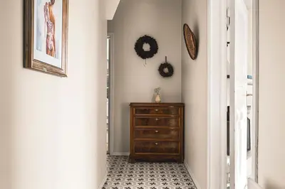 a hallway with a dresser and a clock on the wall at A Dream Home with Spectacular Views - NEW! in Bergen