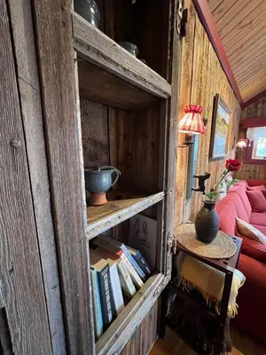 a wooden cabinet with a bowl on it with books at Idyllisk feriested in Gol