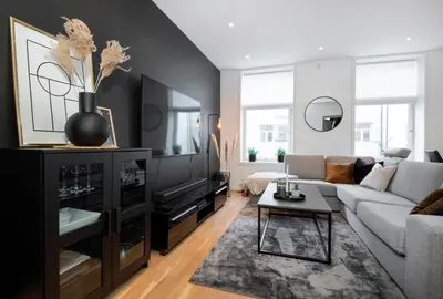 a living room with a couch and a table at Spacious 2-room in the city center, easy access to everything in Ålesund