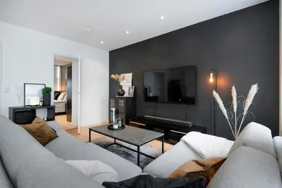a living room with a couch and a tv at Spacious 2-room in the city center, easy access to everything in Ålesund