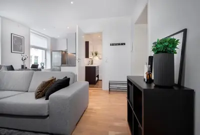 a living room with a couch and a table at Spacious 2-room in the city center, easy access to everything in Ålesund
