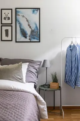 a bedroom with a bed and a table with a lamp at Central 4 room apartment in Bergen