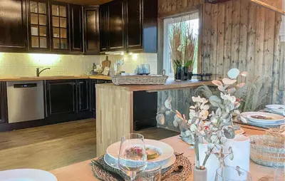 a kitchen with a table with plates of food on it at Lovely Home In Sjusjøen With Sauna in Sjusjøen