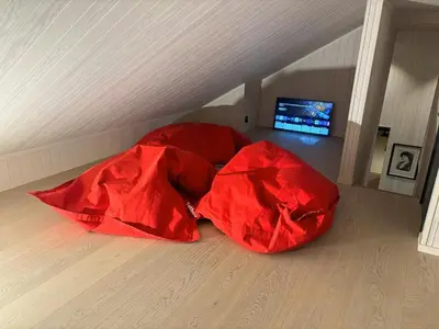 two red covers on the floor of a attic at Architect Cabin With Ski-In Near Trysil in Trysil