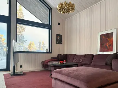 a living room with a couch and a table at Architect Cabin With Ski-In Near Trysil in Trysil