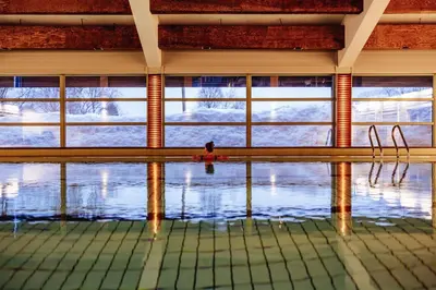 a swimming pool with a window in the water at Kvikne Fjellhotell & Kafé in Tynset