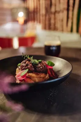 a black plate of food on a table at Kvikne Fjellhotell & Kafé in Tynset
