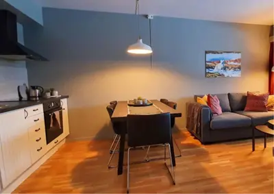 a living room with a couch and a table at Kvikne Fjellhotell & Kafé in Tynset