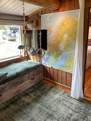 a room with a swinging bed and a map at Log Cabin With 360-Degree Views Near Trysil in Trysil