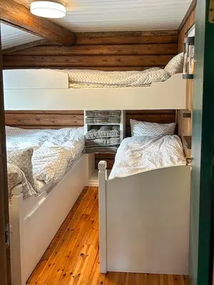 two bunk beds in a room with wooden walls at Log Cabin With 360-Degree Views Near Trysil in Trysil