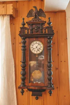 an old grandfather clock hanging on a wall at Solyun in Hol