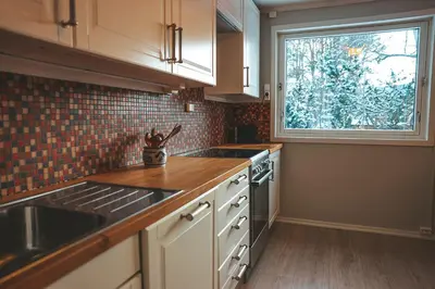 a kitchen with a sink and a window in it at Solyun in Hol