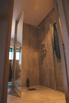 a shower with a glass door in a bathroom at Solyun in Hol