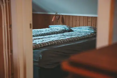 two beds with blue pillows in a room at Close to cross-country skiing, slalom slope and mountains - Soltun Geilo! in Hol