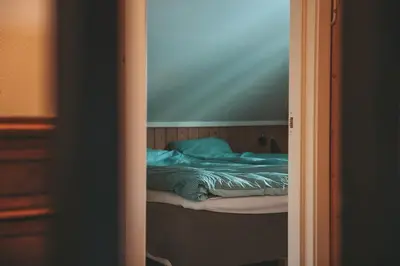 a small bed in a room with a mirror at Close to cross-country skiing, slalom slope and mountains - Soltun Geilo! in Hol