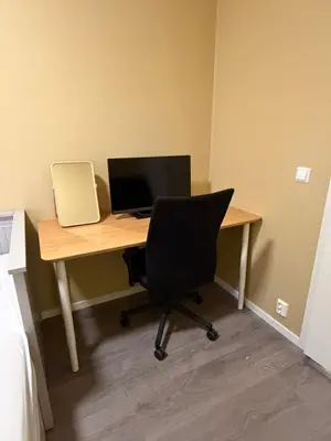 an office desk with a computer monitor and a chair at Modern apartment in Raufoss in Raufoss
