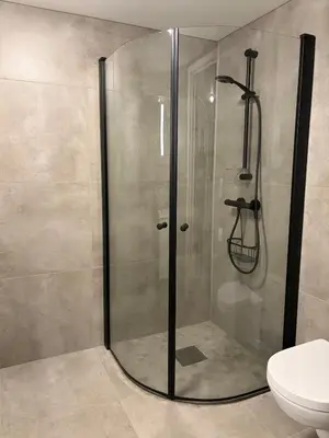a shower stall in a bathroom with a toilet at Modern apartment in Raufoss in Raufoss
