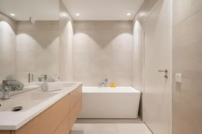 a bathroom with a tub and a sink and a shower at Bellevue Penthouse - Exclusive Design in Bergen