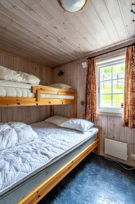 two bunk beds in a room with a window at Cozy ski in & out cabin Hemsedal in Hemsedal