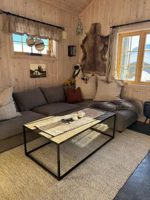 a living room with a couch and a coffee table at Cozy ski in & out cabin Hemsedal in Hemsedal