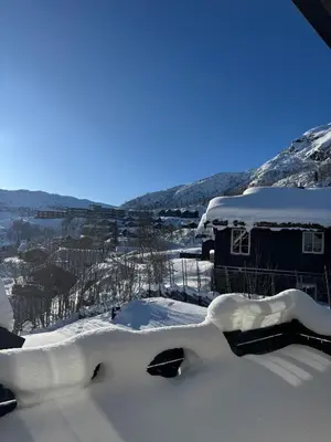 a house covered in snow in the mountains at Cozy ski in & out cabin Hemsedal in Hemsedal
