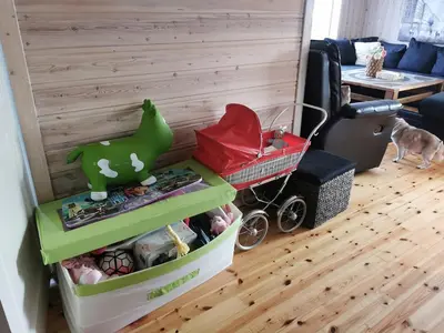 a childs play area with a toy cart and a room at Cozy family cottage with a view