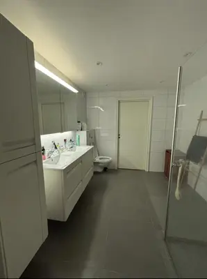 a white bathroom with a sink and a toilet at Etterstad in Lii