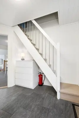 a white staircase in a room with a fire hydrant at High standard, large cabin with amazing view in Stryn