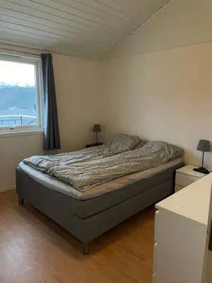 a bed in a bedroom with a window and a bed sidx sidx sidx at Bolig på Kaupanger in Kaupanger